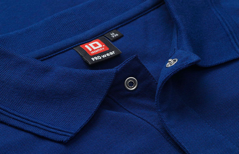 ID 0330 PRO Wear poloshirt | trykknap nærbillede med logo