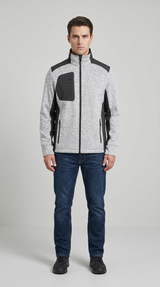 Mand iført en grå og sort fleecejakke med lynlås og mørkeblå jeans mod en neutral baggrund.