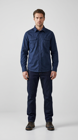 Mand i mørkeblå langærmet skjorte, mørke jeans og brune støvler mod en hvid baggrund.